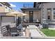 Side view of a two-story home with a patio, seating, and an outdoor umbrella at 2135 W 40Th Ave, Denver, CO 80211