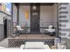Charming front porch with chairs, plants, and decorative details on a gray brick home at 2135 W 40Th Ave, Denver, CO 80211