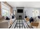 Modern living room with a brick accent wall, fireplace, and stylish furniture at 2135 W 40Th Ave, Denver, CO 80211