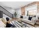 Bright living room features a decorative brick wall, large window, and modern furnishings at 2135 W 40Th Ave, Denver, CO 80211