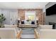 Bright living room with a brick accent wall, modern furnishings, and natural light at 2135 W 40Th Ave, Denver, CO 80211