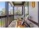 Inviting front porch with two wood chairs, a table, and a gray brick wall at 2135 W 40Th Ave, Denver, CO 80211