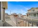 View from balcony of the neighborhood with multiple homes and the sky in the background at 46566 Avery Ln, Bennett, CO 80102
