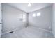 Empty bedroom showcasing neutral walls, carpet flooring, window, and natural light at 46566 Avery Ln, Bennett, CO 80102