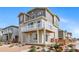 Modern home with charming two-story exterior and a small deck, complemented by drought-tolerant landscaping at 46566 Avery Ln, Bennett, CO 80102