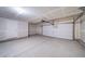 Spacious garage with a large door, equipped with an automatic door opener, plus an additional entry door at 46566 Avery Ln, Bennett, CO 80102