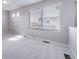 Bright hallway with soft carpet and natural light through a window, freshly painted in a neutral color at 46566 Avery Ln, Bennett, CO 80102
