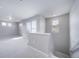 Bright hallway with soft carpet and natural light through large windows, freshly painted in a neutral color at 46566 Avery Ln, Bennett, CO 80102