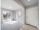 A bright living room featuring light hardwood flooring and a sliding glass door at 46566 Avery Ln, Bennett, CO 80102