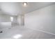 Empty living room showcasing neutral walls, carpet flooring, multiple windows, and natural light at 46566 Avery Ln, Bennett, CO 80102