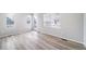 A spacious living room with light hardwood flooring and lots of natural light at 46566 Avery Ln, Bennett, CO 80102