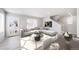 A living room with a staircase, sofa, and dining table at 46566 Avery Ln, Bennett, CO 80102