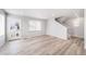 A bright living room with light hardwood flooring and staircase at 46566 Avery Ln, Bennett, CO 80102