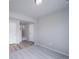 Versatile room featuring hardwood flooring and soft carpet, with neutral paint and a well-lit open doorway at 46566 Avery Ln, Bennett, CO 80102