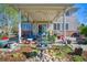 Backyard patio with furniture, string lights, fountain, and lush landscaping at 6800 Saddleback Ave, Firestone, CO 80504