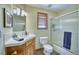 This bathroom offers a white vanity, a shower with glass doors, and neutral paint at 6800 Saddleback Ave, Firestone, CO 80504