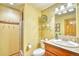 Bright bathroom featuring a vanity, toilet, mirror, and a walk-in shower with neutral tile surround at 6800 Saddleback Ave, Firestone, CO 80504
