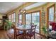 Cozy breakfast nook featuring hardwood floors, large windows, and a sliding door at 6800 Saddleback Ave, Firestone, CO 80504