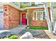 Inviting red front door with brick surround and decorative accents at 6800 Saddleback Ave, Firestone, CO 80504