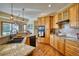 Spacious kitchen featuring granite countertops, hardwood floors, and modern appliances at 6800 Saddleback Ave, Firestone, CO 80504