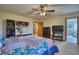 Spacious main bedroom showing ensuite bathroom access and featuring a ceiling fan and closet organizers at 6800 Saddleback Ave, Firestone, CO 80504