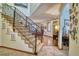Elegant staircase with wrought iron railings and hardwood floors at 6800 Saddleback Ave, Firestone, CO 80504