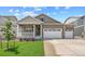 Charming single-Gathering home with a two-car garage, stone accents, a welcoming porch, and a manicured front lawn at 3197 Belleville Ridge Rd, Elizabeth, CO 80107