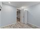 A bright bedroom with wood-look flooring, neutral walls, and an attached closet for modern comfort at 977 S Reed St, Lakewood, CO 80226