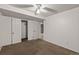 A carpeted bedroom featuring a ceiling fan, a closet, and an access door at 977 S Reed St, Lakewood, CO 80226
