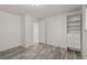 Bright bedroom with hardwood floors, neutral walls, and closet space, offering a versatile and inviting atmosphere at 977 S Reed St, Lakewood, CO 80226