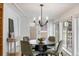 Modern dining area with stylish black table, comfortable seating, and plenty of natural light from the windows at 977 S Reed St, Lakewood, CO 80226
