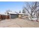 A single story brick house with a gray garage door and long driveway at 977 S Reed St, Lakewood, CO 80226