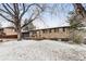 Charming brick home with a well-manicured front yard, mature tree and attached garage at 977 S Reed St, Lakewood, CO 80226