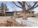 Charming brick home with a well-manicured front yard and attached garage at 977 S Reed St, Lakewood, CO 80226