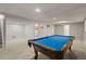 Spacious game room with a billiards table and ample seating, creating a fun and recreational space for entertainment at 977 S Reed St, Lakewood, CO 80226