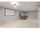 Entertainment space with a pool table, projector screen, and recessed lighting, perfect for hosting game nights at 977 S Reed St, Lakewood, CO 80226