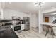 Bright kitchen featuring stainless steel appliances, black countertops, and white cabinets for a clean, modern look at 977 S Reed St, Lakewood, CO 80226