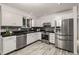 Modern kitchen with white cabinets, stainless steel appliances, and sleek countertops at 977 S Reed St, Lakewood, CO 80226