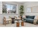 Bright and airy living room featuring neutral paint, a modern sofa and a large window at 977 S Reed St, Lakewood, CO 80226