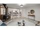 Open-concept living area with a wood-burning stove, a breakfast bar and views into the kitchen at 977 S Reed St, Lakewood, CO 80226