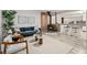 Stylish living room featuring a wood-burning stove, a view into the kitchen and modern furnishings at 977 S Reed St, Lakewood, CO 80226