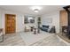 Cozy living room featuring a wood-burning stove, stylish furniture, and plenty of natural light at 977 S Reed St, Lakewood, CO 80226