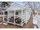 Exterior view of a white outbuilding with covered storage for firewood at 977 S Reed St, Lakewood, CO 80226