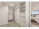 Well-organized walk-in closet with custom shelving, providing ample storage and easy access to clothing and accessories at 977 S Reed St, Lakewood, CO 80226