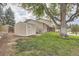 View of a spacious backyard with lush green grass and a storage shed next to the home at 9014 W Harvard Dr, Lakewood, CO 80227