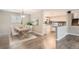 Dining area with a light wood table and seating for four, plus modern decor at 9014 W Harvard Dr, Lakewood, CO 80227