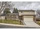 Charming two-story home with brick and siding exterior, manicured lawn, and a two-car garage at 9014 W Harvard Dr, Lakewood, CO 80227