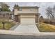 Charming two-story home with brick and siding exterior, manicured lawn, and a two-car garage at 9014 W Harvard Dr, Lakewood, CO 80227