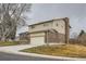 Two-story home with a brick and siding exterior, featuring a two-car garage and a well-kept lawn at 9014 W Harvard Dr, Lakewood, CO 80227