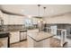 Well-lit kitchen with stainless steel appliances, granite countertops, and modern fixtures at 9014 W Harvard Dr, Lakewood, CO 80227